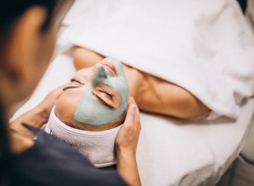 cosmetologist-applying-mask-face-client-beauty-salon-1600x1067